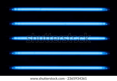 Ultraviolet lamps arranged horizontally on a black background