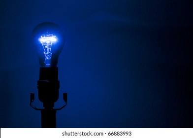 An Ultraviolet Purple Blacklight Against A Wall In A Lamp.