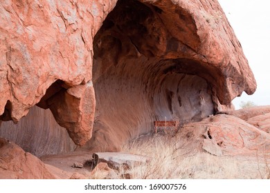 Uluru - Ayers Rock. Aboriginal Sacred Place. UNESO World Heritage. Red Sandstone Rock Closeup Of Caves.