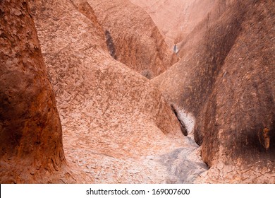 Uluru - Ayers Rock. Aboriginal Sacred Place. UNESO World Heritage. Red Sandstone Rock Closeup With Day Changing Color Painting.