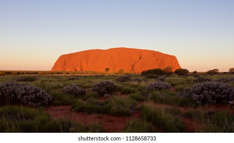 ULURU,AUSTRALIA - AUGUST 2016: Ayers Rock illuminated by the sunset light in the red centre of Australia