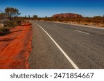 Uluru-Kata Tjuta National Park, Northern Territory, Australia: Outback highway - Kata Tjuta Road with Uluru in the background.