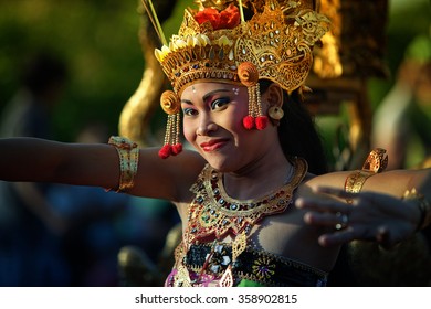 ULUWATU, BALI - CIRCA January 2011 - A woman dances during a Kecak Fire Dance ceremony at the Uluwatu Temple. The ancient Hindu temple features ocean cliff views and wild monkeys.