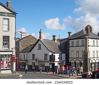 Ulverston, Cumbria, United Kingdom - 16 September 2021: View Of The Town Centre In Ulverston Cumbria With People Walking Past Shops And War Memorial