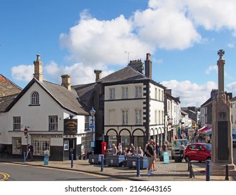 Ulverston, Cumbria, United Kingdom - 16 September 2021: View Of The Town Centre In Ulverston Cumbria With People Walking Past Shops And The Weekly Market