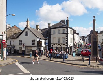 Ulverston, Cumbria, United Kingdom - 16 September 2021: View Of The Town Centre In Ulverston Cumbria With People Walking Past Shops And The Weekly Market