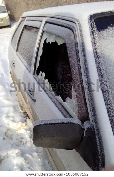 Ulyanovsk / RUSSIA - 02-09-2018: Night vandals broke\
the window of a parked\
car.