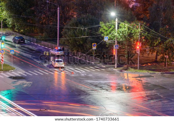 Ulyanovsk, Russia - April 10, 2020. At the\
crossroads at night, the driver violated and knock down a\
pedestrian. The police draw up a road traffic accident. Traffic\
violation. Police inspector\
car.