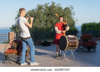 Ulyanovsk, Russia - July 13, 2021: Street Musicians Play Scottish Music On Bagpipes, Drums, Flute, The Musician Is Dressed In Scottish Clothing.