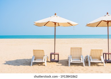 Umbrella and chair around beach sea ocean on blue sky for travel vacation