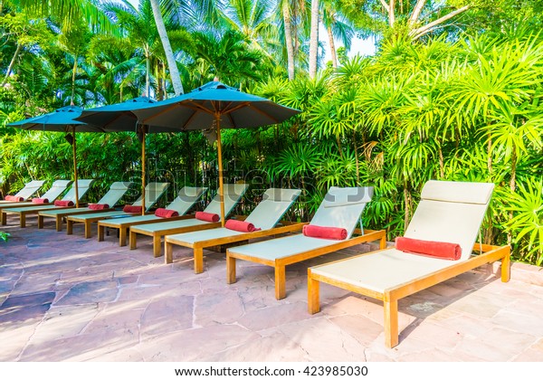 Umbrella Chair Around Outdoor Swimming Pool Stock Photo