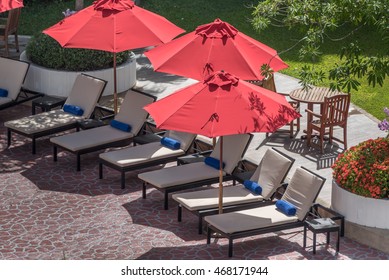 Umbrella and chairs in the garden.Outdoor furniture beside the swimming pool.