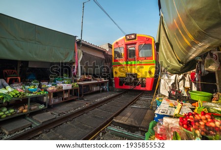 Umbrella Fresh Market on the Railroad Track, Mae Klong Train Station, Bangkok, Thailand on a Sunny Day