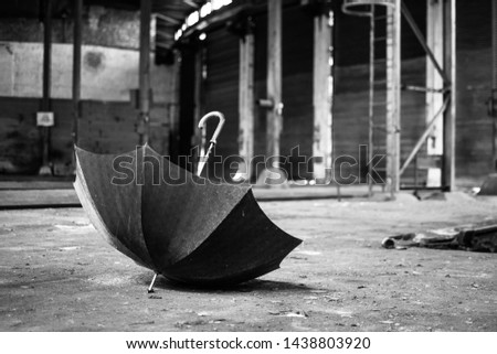 Umbrella lying in abandoned trainworkshop with unsharp background.