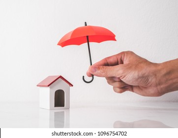 Umbrella And Toy House For Protect Your House And Property Concept.