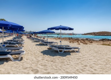 Umbrellas And Beach Loungers In Sandy Mediterranean Beach, Ayia Napa, Cyprus. 