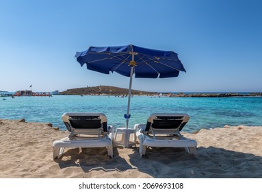 Umbrellas And Beach Loungers In Sandy Mediterranean Beach, Ayia Napa, Cyprus.