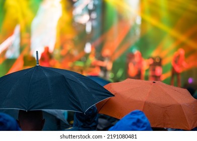 Umbrellas During A Music Concert In The Rain