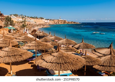 Umbrellas On Beach  In Coral Reef,   Sharm El Sheikh,  Egypt