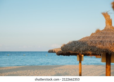 Umbrellas On The Beach. Straw Umbrella On The Beach