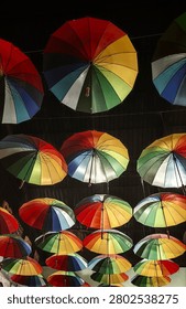 Umbrellas with rainbow pattern hung on the ceiling