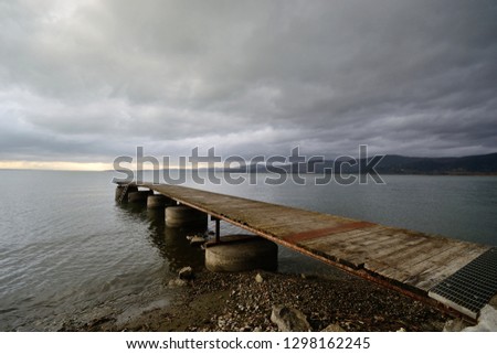 Umbria,Italy, Trasimeno lake view with a jetty in foreground on winter