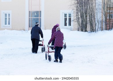 Umea, Norrland Sweden - March 4, 2021: Older Ladies Are Out With Their Walkers In The Snow 