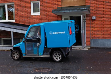 Umea, Norrland Sweden - October 9, 2019: The Mail Carrier's Blue Car Has Parked To Deliver Letters And Bills