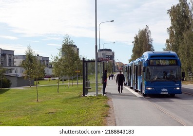 UMEA, SWEDEN ON AUGUST 30. View Of A Modern Suburban Settlement, Street, And Traffic On August 30, 2016 In Umea, Sweden. Bus Stop And Lawns On This Side. Unidentified People.