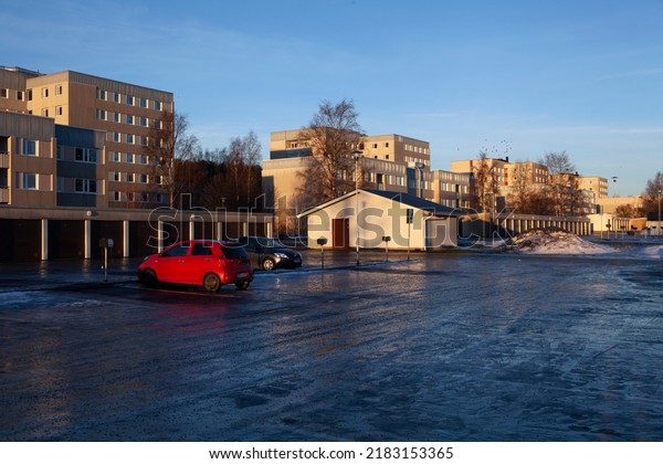 UMEA, SWEDEN ON DECEMBER 20. View of a\
modern residential area during the winter solstice time on December\
20, 2016 in Umea, Sweden. Icy ground,\
daylight.