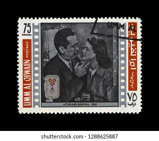 UMM AL QIWAIN, UNITED ARAB EMIRATES - CIRCA 1970s: Canceled Stamp Printed In UAE Shows Casablanca Film Scene: Ingrid Bergman (Ilsa Lund) And Humphrey Bogart (Rick Blaine), Circa 1970s.