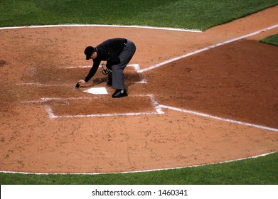 Umpire Dusting Off Home Plate