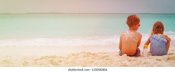 Un Protection- Little Boy And Girl With Suncream At Beach