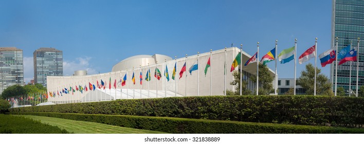 UN United Nations General Assembly Building With World Flags Flying In Front - September 1, 2015, First Avenue, New York City, NY, USA