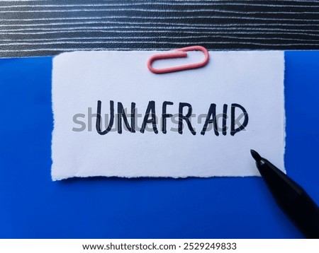 Unafraid writting on table background.