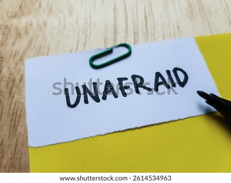 Unafraid writting on table background.