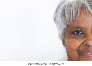 Unaltered portrait of half face of happy senior biracial female patient smiling, with copy space. Friendly, hospital, medical and healthcare services. - Powered by Shutterstock