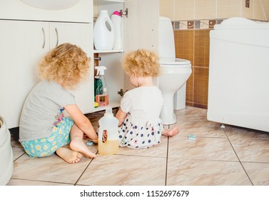 Unattended Children Play Quietly At Bathroom With Dangerous Household Chemicals. Safety Hazard At Home Concept. Keep Away From Children`s Reach.