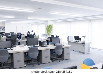 Unattended office with desks and computers - Shutterstock ID 2184254181
