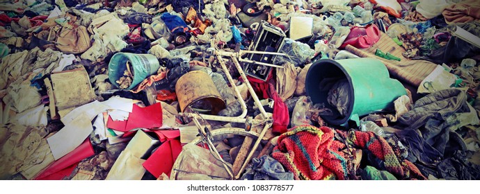 unauthorized junkyard with many abandoned objects symbol of the human incivility with vintage effect