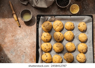 Unbaked chocolate and lemon yeast brioches on baking tray. - Powered by Shutterstock