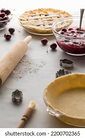 An Unbaked Pie Shell With Fresh Cherry Pie Filling In Behind. 