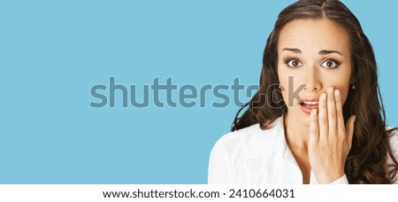 Unbelievable news! Excited surprised, shocked businesswoman. Business woman covering open mouth by her hand. Isolated aqua blue marine background. Wide banner composition. 