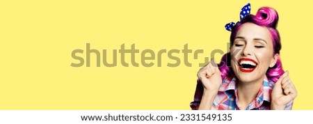 Unbelievable news! Excited surprised, very happy purple woman. Pin up girl with open mouth and closed eyes with raised hands. Retro and vintage concept. Yellow background. Wide composition image.