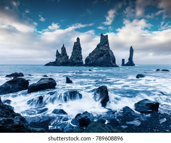 Unbelievable seascape of Reynisdrangar cliffs in the Atlantic ocean. Fantastic summer morning on south Iceland, Vik village location, Europe. Beauty of nature concept background.
