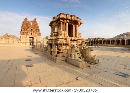 Unbelievable stone chariot in the courtyard of Vittala Temple at sunset in Hampi, Karnataka, India