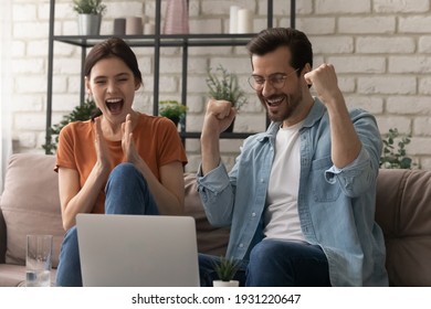 Unbelievable success. Overjoyed young husband wife scream yes super as lucky winners by laptop pc get mortgage loan approval in bank email. Emotional spouses celebrate great victory at betting lottery