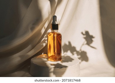 Unbranded bottles in mockup style on podium with shadow top view. Tube of eye oil on a white background. Beauty background with facial cosmetic products. Spa, beauty concept.