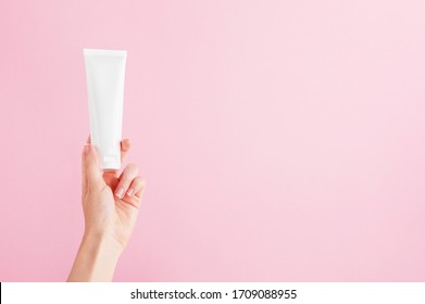 Unbranded Flacon For Cream, Concealer, Toiletry. Plastic Tube In Female Hand. Container For Professional Cosmetics Products. Skincare And Beauty Concept. Mockup, Copy Space. Isolated On Pink