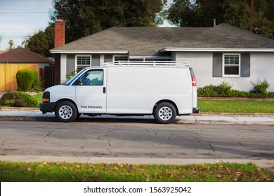 An Unbranded Home Service Van Parked In Front Of A House For Repairs Or Handyman Work.